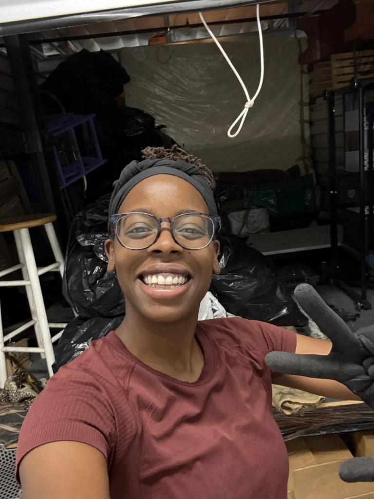 Hadiyah taking a selfie in a garage before organizing