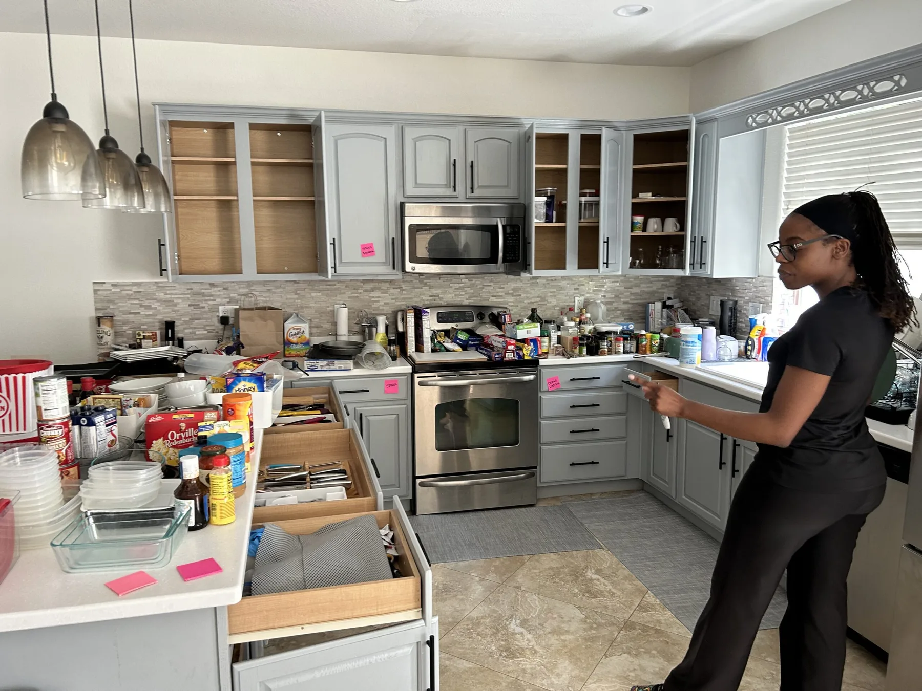 Hadiyah Alexander organizing a kitchen during a project