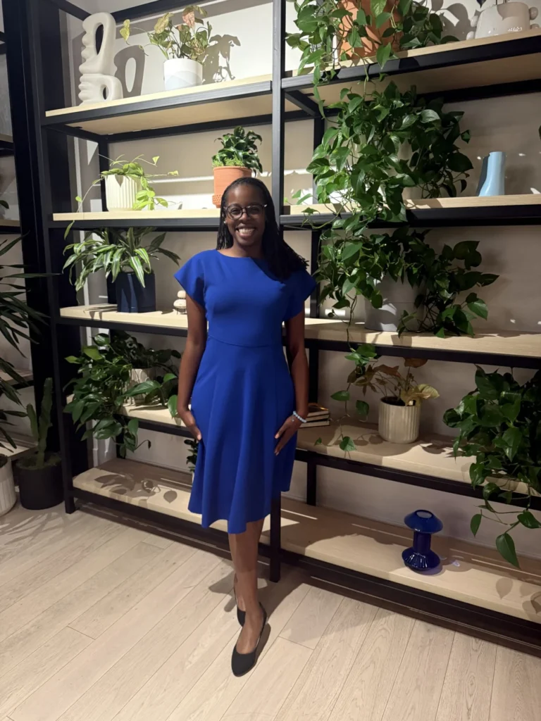 Hadiyah Alexander standing in front of shelves of plants