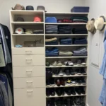Closet shelves with folded sweaters, hats, and shoes