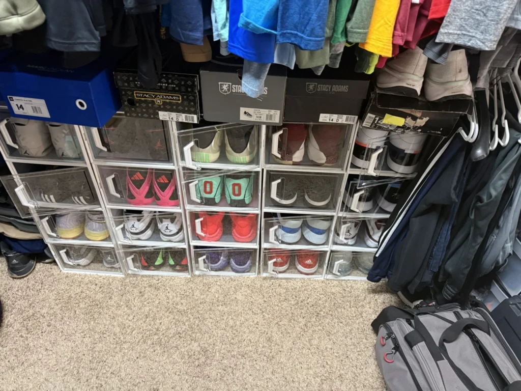 Walk-in closet with shoes in cubbies and clothes sorted by color