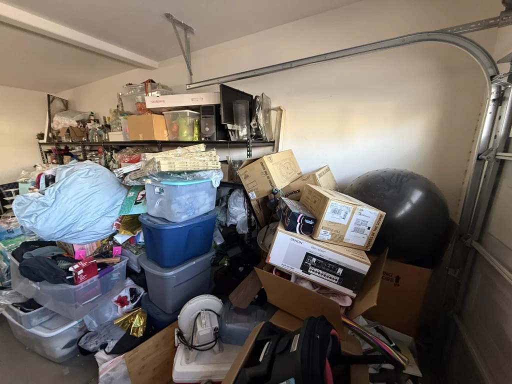 Garage packed with bins and boxes before organizing