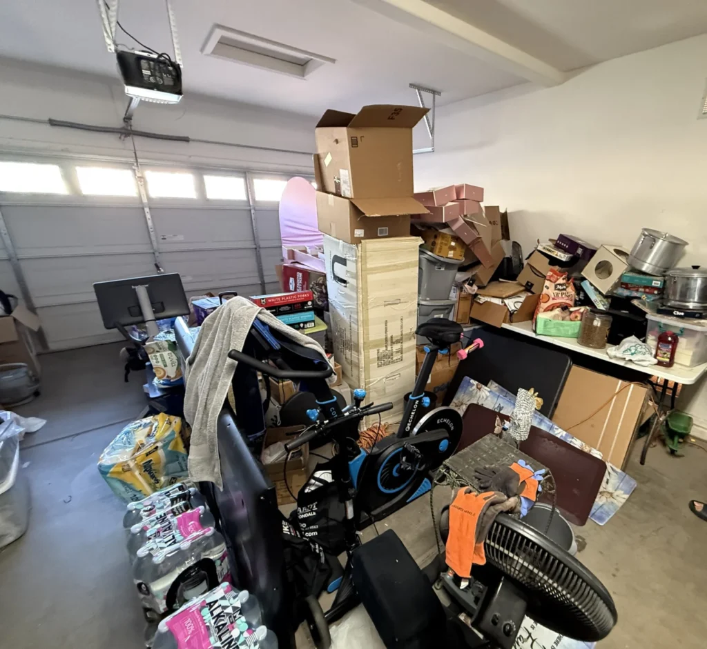 Garage workbench area covered in items before organizing