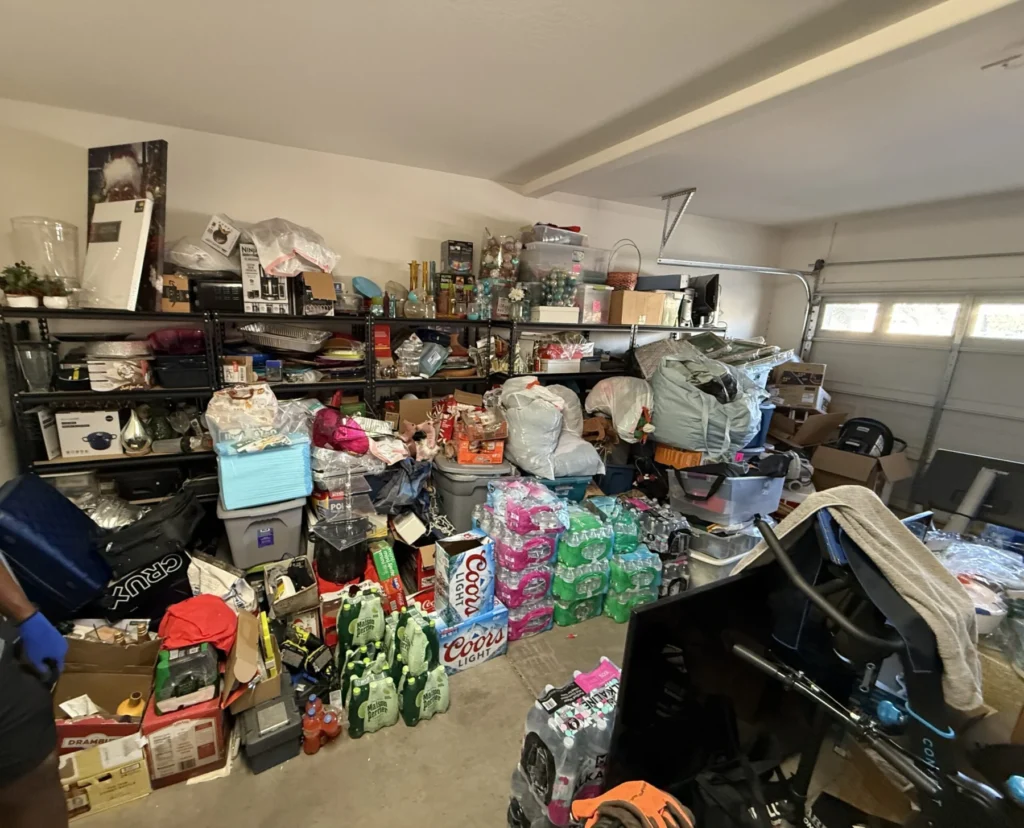 Garage filled with bins and household items before organizing