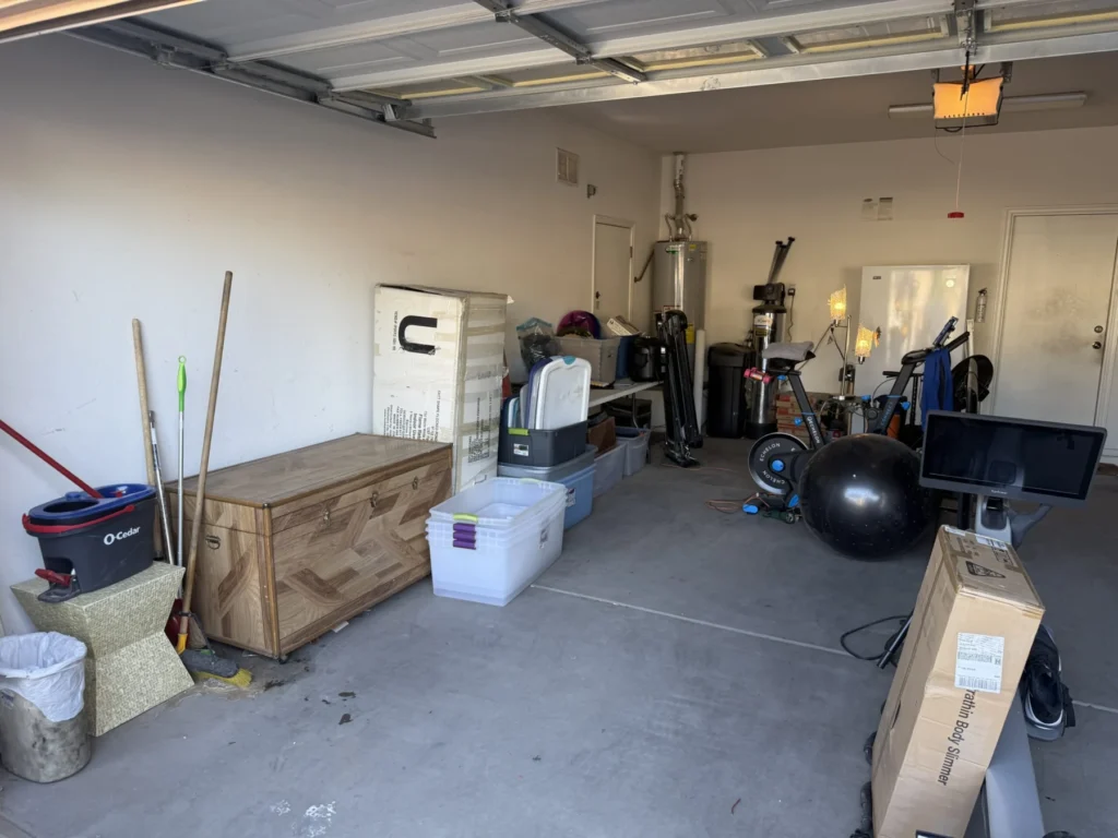 Cleared garage with a workbench and exercise equipment