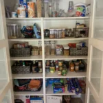 Pantry shelves with food sorted into bins by category