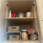 Cabinet with lidded bins and pantry jars