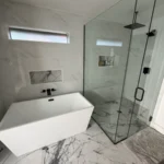 Bathroom with a freestanding tub and glass shower