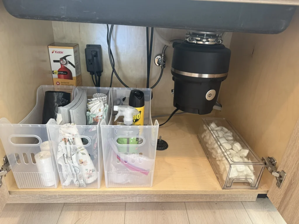 Under-sink cabinet organized with clear bins