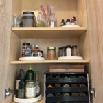 Kitchen cabinet with coffee and tea supplies sorted on shelves