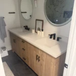 Bathroom vanity with a double sink and round mirrors