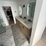 Bathroom with a double vanity and marble floor