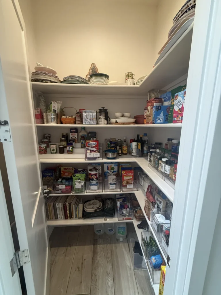 Pantry with corner shelves holding food and kitchen supplies