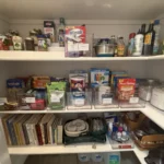 Pantry shelves with food grouped above and cookbooks below