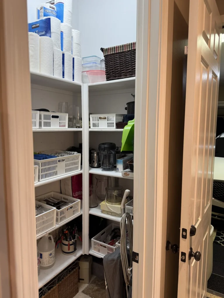 Supply closet with labeled bins, seen from the doorway
