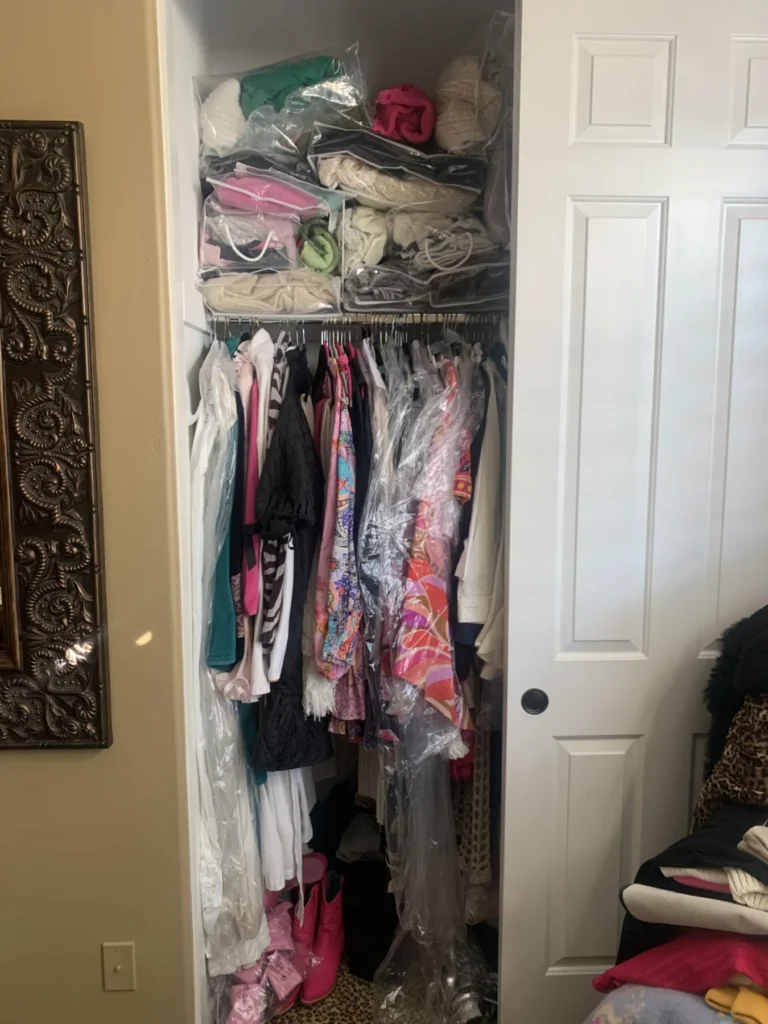 Crowded reach-in closet before organizing