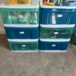 Teal storage drawers holding toys