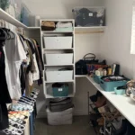 Walk-in closet with shelving, bins, and a built-in desk