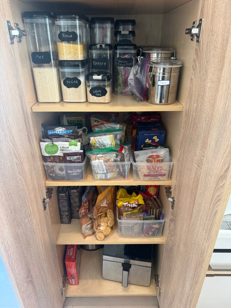 Matching clear canisters sourced and organized in a kitchen cabinet